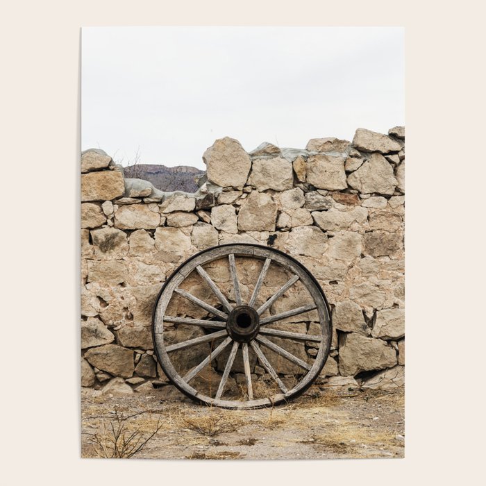 Wagon wheel against a stone fence at Hueco Tanks State Park northwest