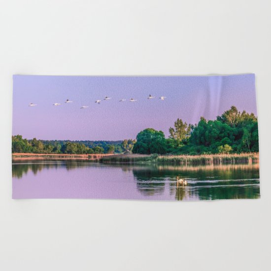 Swans are flying Beach Towel