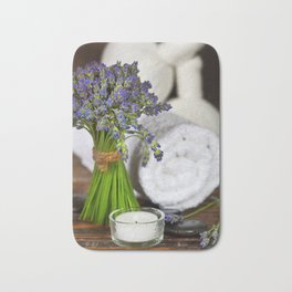 Fresh  lavender flowers, zen stones,Herbal massage balls , candle and towel over wooden surface Badematte