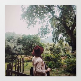 a woman in front of a farm Canvas Print