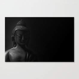 black and white picture of buddha statue isolated on black background Canvas Print