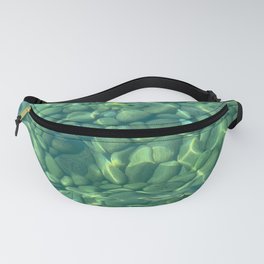 Beach pebbles under a crystal clear green water Fanny Pack