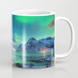 Aurora borealis over the sea coast, snowy mountains and city lights at night. Northern lights in Lofoten islands, Norway. Starry sky with polar lights. Winter landscape with aurora reflected in water Coffee Mug