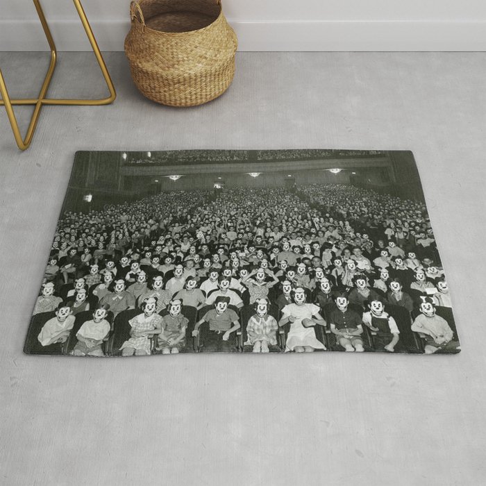 One-thousand Bizzaro Masked Mickeys watching cartoons in theatre black and white photograph Rug