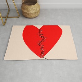 Fixing a broken heart concept with two halves of heart sewed with black thread Area & Throw Rug