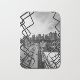 Views of New York City | Skyline and Brooklyn Bridge Through the Fence | Black and White Bath Mat