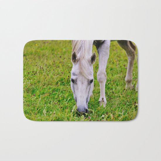 White horse on green meadow Bath Mat