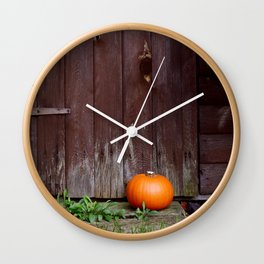 Orange pumpkin by wooden door Wall Clock
