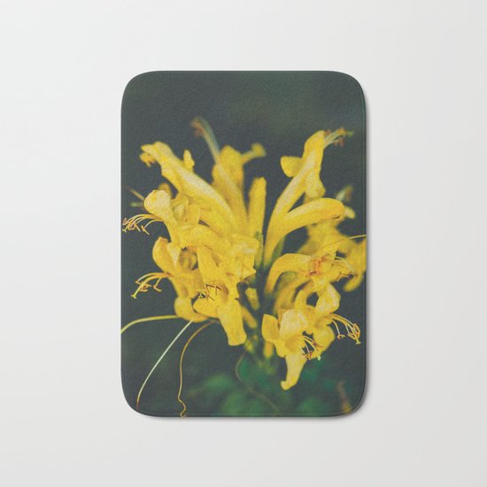 Beautiful yellow flower on black background Bath Mat