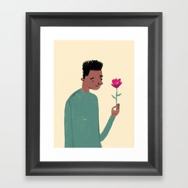 African American Boy in Green Shirt looking at pink flower Framed Art Print