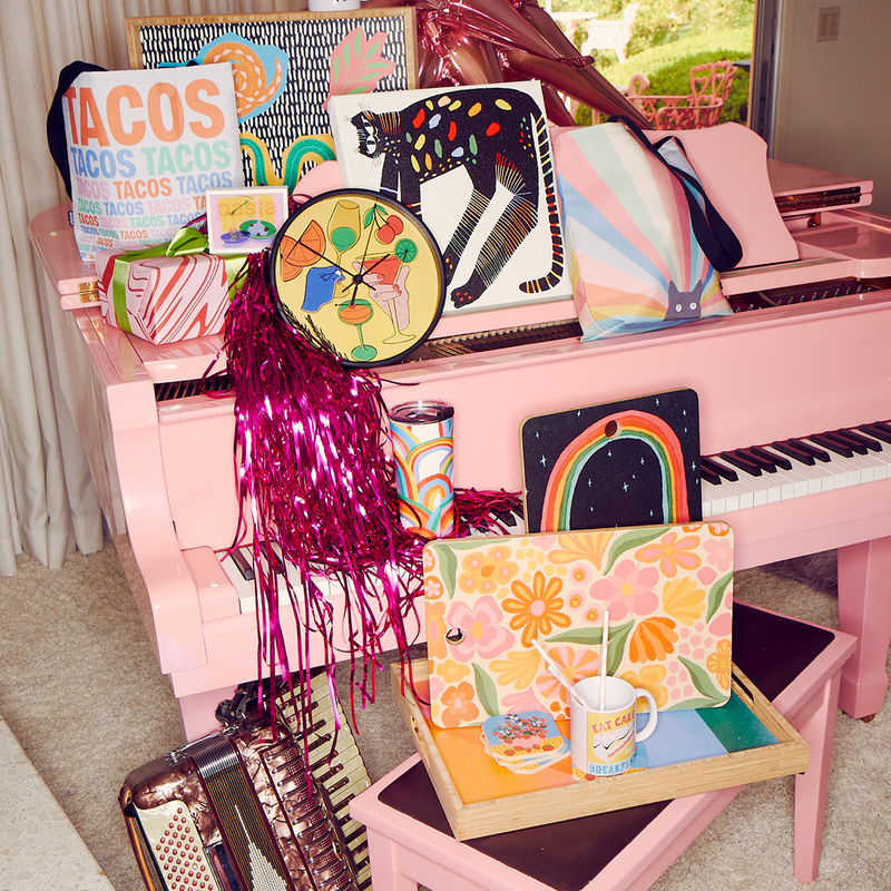 bags, tabletop accessories, canvas prints and more displayed on a pink piano