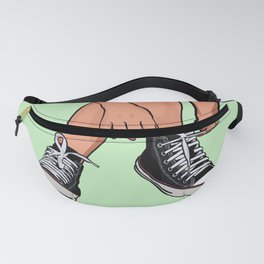 Woman tying black shoes on her feet - green background Fanny Pack