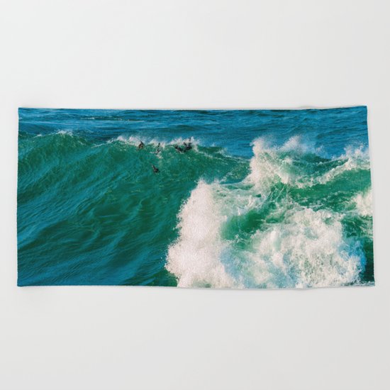 Ducks riding a wave Beach Towel