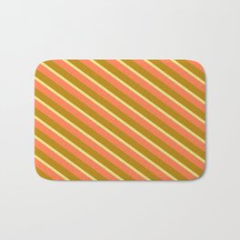[ Thumbnail: Coral, Dark Goldenrod, and Tan Colored Pattern of Stripes Bath Mat ]