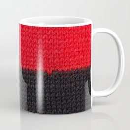 beautiful black and red knitted fabric with drawings in the strip, close up Coffee Mug