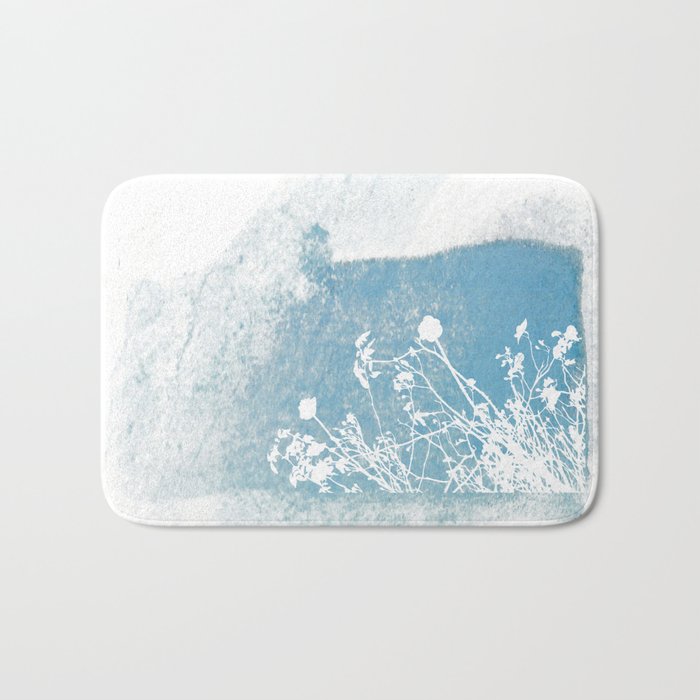 Shadow of wild flowers on a blue watercolor wall Bath Mat