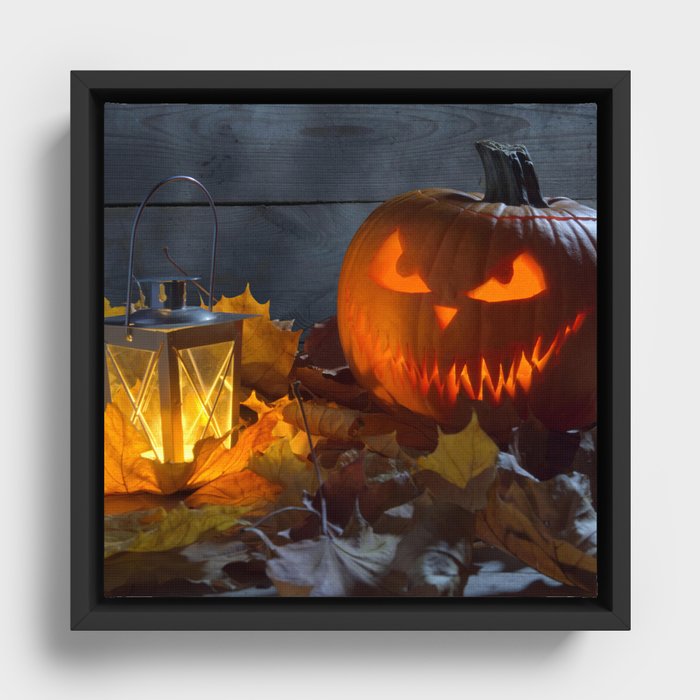 Spooky Jack O Lantern Among Dried Leaves on Wooden Fence Framed Canvas