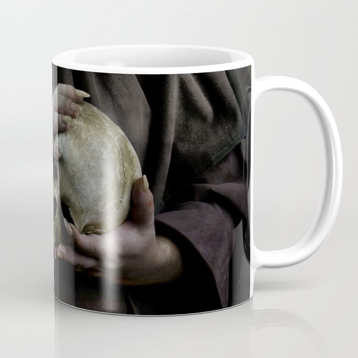 Holding a male skull Coffee Mug