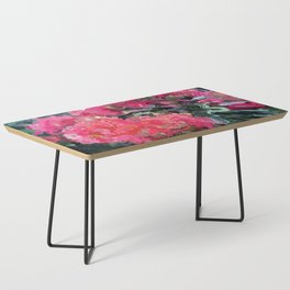 Red flower blossoms amid lush green foliage Coffee Table