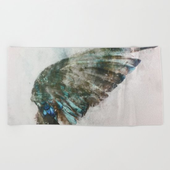 An angel lost its wing Beach Towel