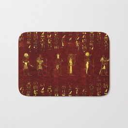 Golden Egyptian Gods and hieroglyphics on red leather Bath Mat