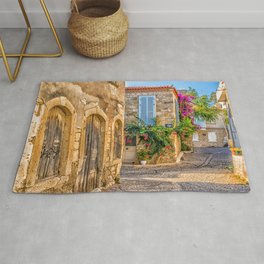 Cobbled street and old stone houses. The town is a popular tou Area & Throw Rug