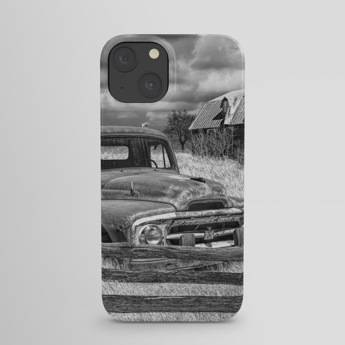 Black and White of Rusted International Harvester Pickup Truck behind wooden fence with Red Barn in iPhone Case