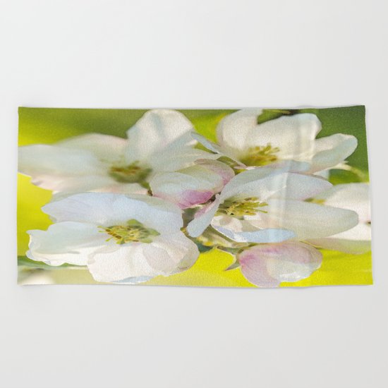 Close-up of Apple tree flowers on a vivid green background - Summer atmosphere Beach Towel