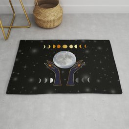 Hands holding the full moon on a starry background with moon phases Area & Throw Rug