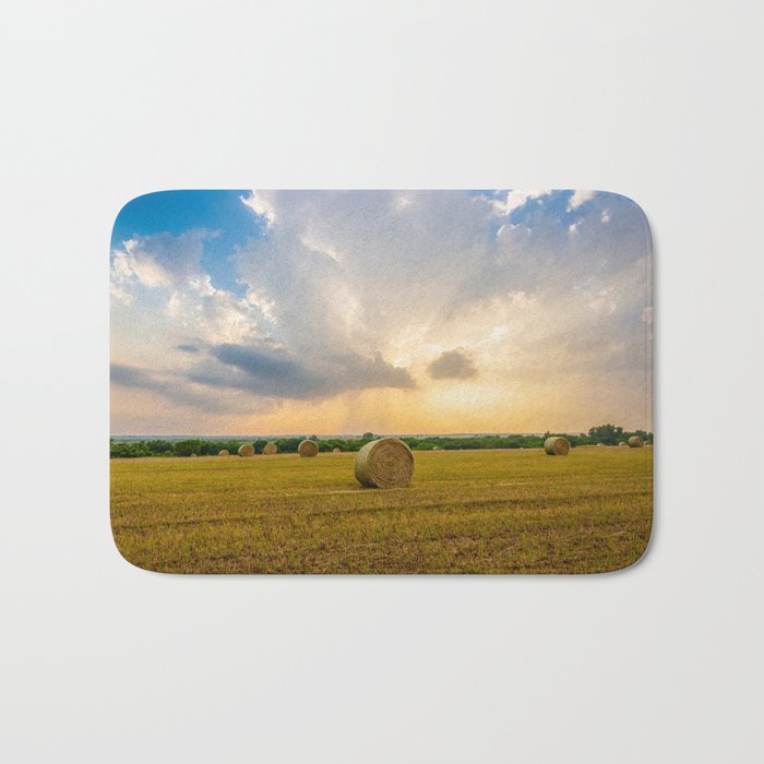 The Best of Times - Round Hay Bales Under a Stormy Sky Filled with Golden Sunlight in Oklahoma Bath Mat