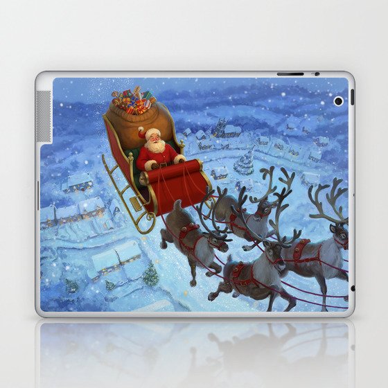 Santa flying over the snowy countryside on Christmas Eve Laptop & iPad Skin