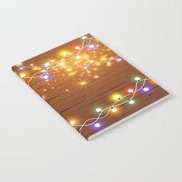 Christmas and New Year design: wooden background with Christmas lights of garland. Vintage illustration, Set of glowing christmas lights. Wooden background.  Notebook