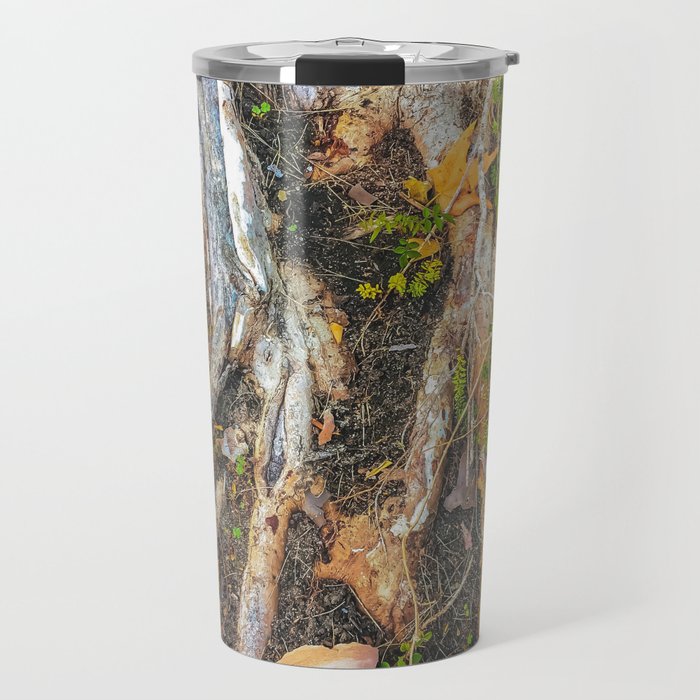 tree roots with green leaves plant on the ground Travel Mug