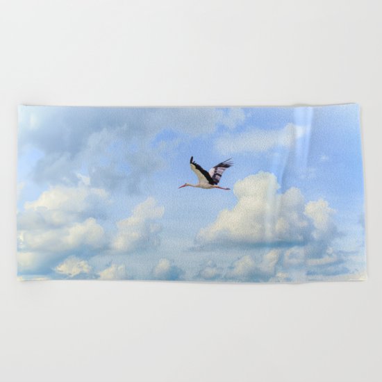 Flying stork Beach Towel