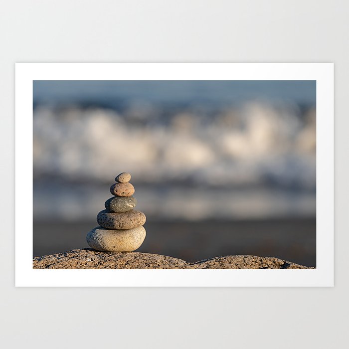 Pebbles stacked on the beach Art Print