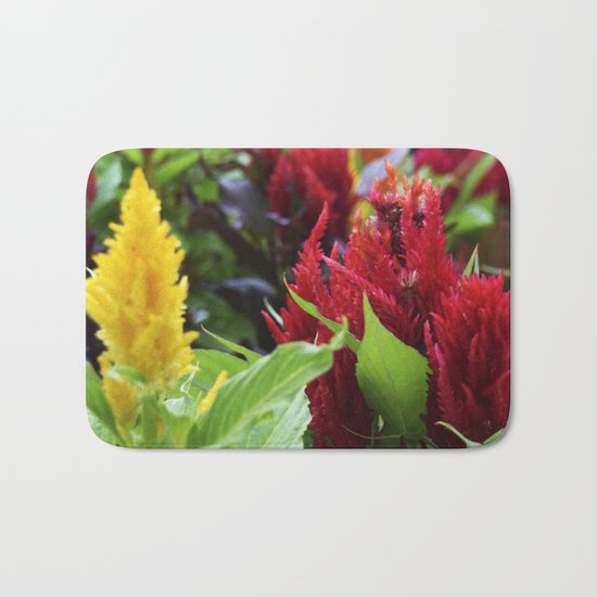red , yellow, and pink flowers planted in the flower bed Bath Mat