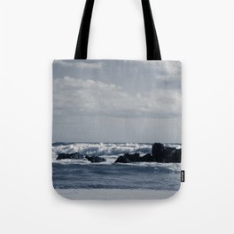 Ionian sea agitated with foamy waves that collide with the rocks on the shore of the coast of Salento in a day of strong wind of Scirocco, interpretation of the monochromatic Tote Bag