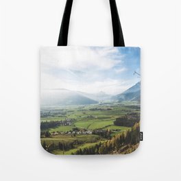 View of farmlands in a misty day Tote Bag