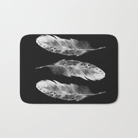Three feathers on black background Bath Mat