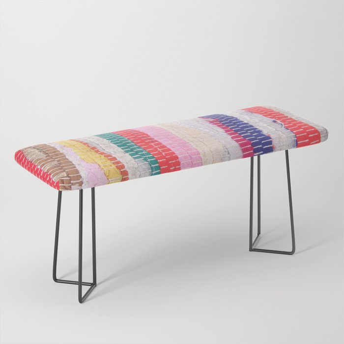 Ethnic stitch textile in multiple colours. Bench