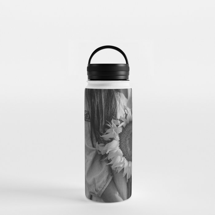 Sunflower; still life portrait young woman holding sunflower in harvest field floral blossom black and white photograph - photography - photographs Water Bottle