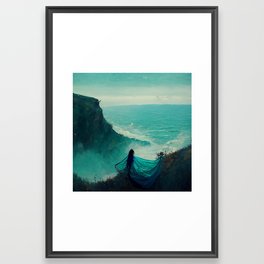 Woman on ocean cliff Framed Art Print