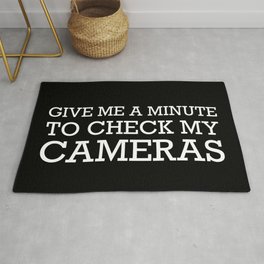 GIVE ME A MINUTE TO CHECK MY CAMERAS Rug