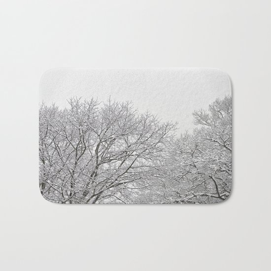 Snow covered tree tops Bath Mat