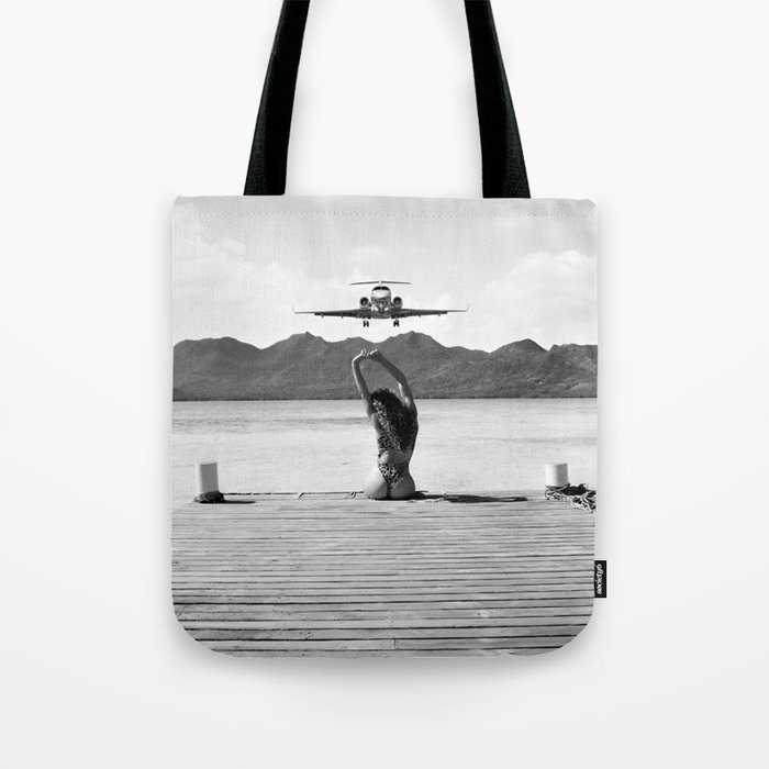Steady as she goes girl in bikini on a dock with plane landing black and white photograph Tote Bag