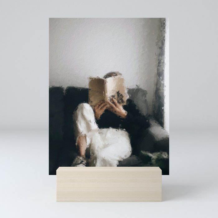 digital oil painting of a faceless woman reading on a sofa Mini Art Print