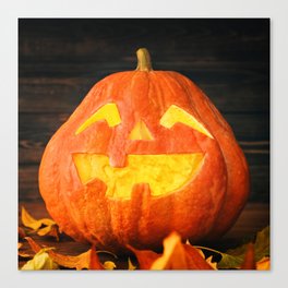 Halloween Pumpkin with Leaves on Wooden Background Canvas Print