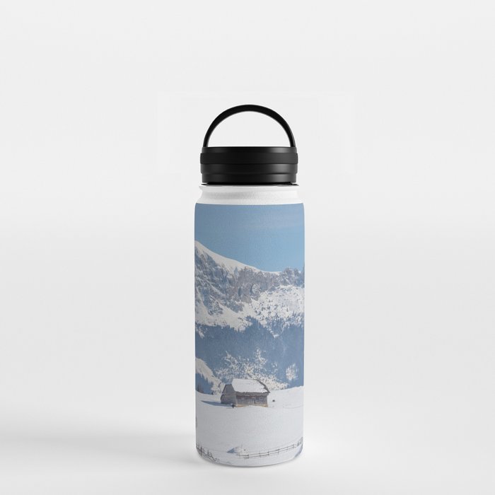 Winter landscape with an old house and Bucegi mountains in the background Water Bottle