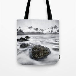 Mountain range in front of wild surf Tote Bag