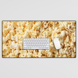 Tasty popcorn on whole background. Food for watching cinema Desk Mat